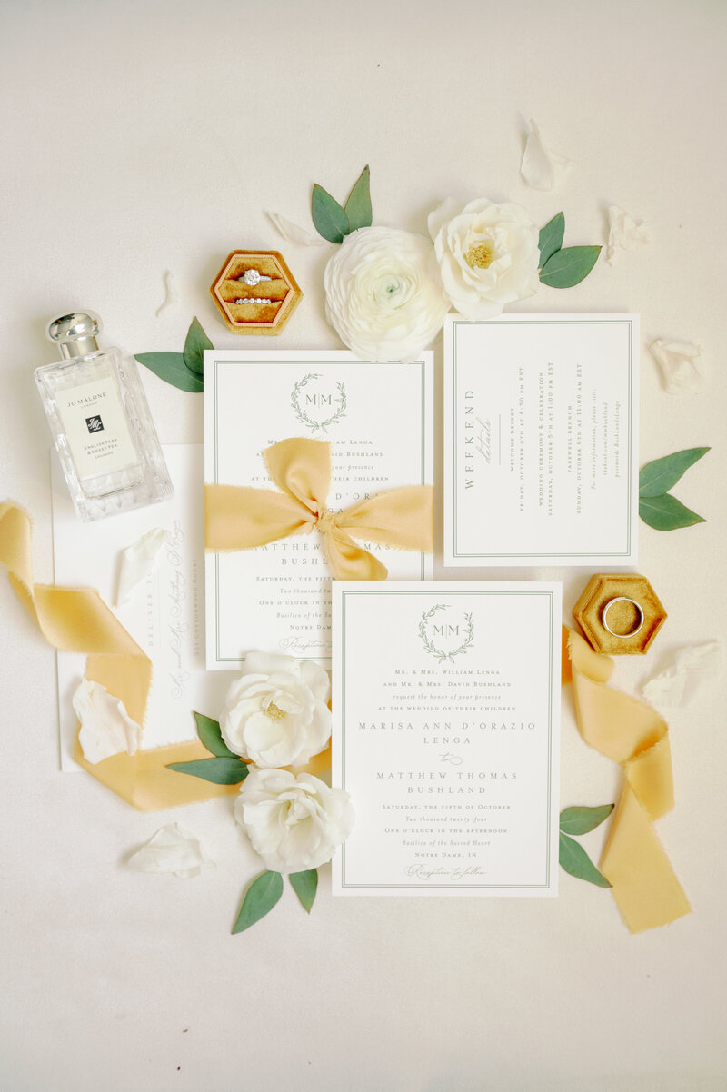 a flat lay with white, gold, and green details