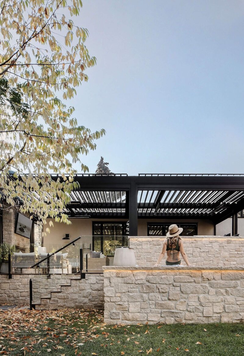 An outdoor living space with a outdoor spa and hotub with accent stone work. 