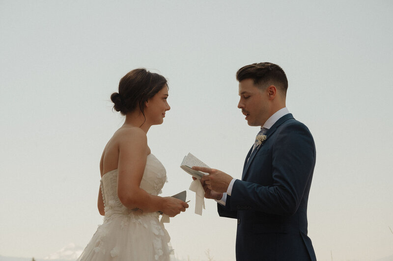 wedding couple holding hands and laughing at their wedding venue after the ceremony