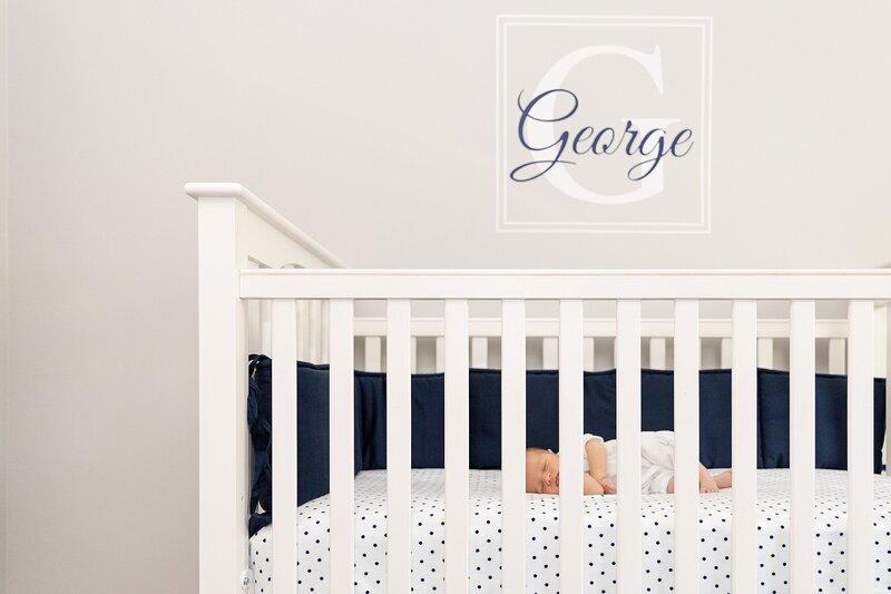 Baby boy sleeping in white crib | Chicago-based newborn photography