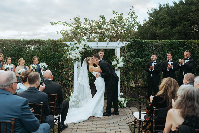 couple kissing on their wedding day, captured by Elsie Goodman, an NYC wedding, engagement and couples photographer