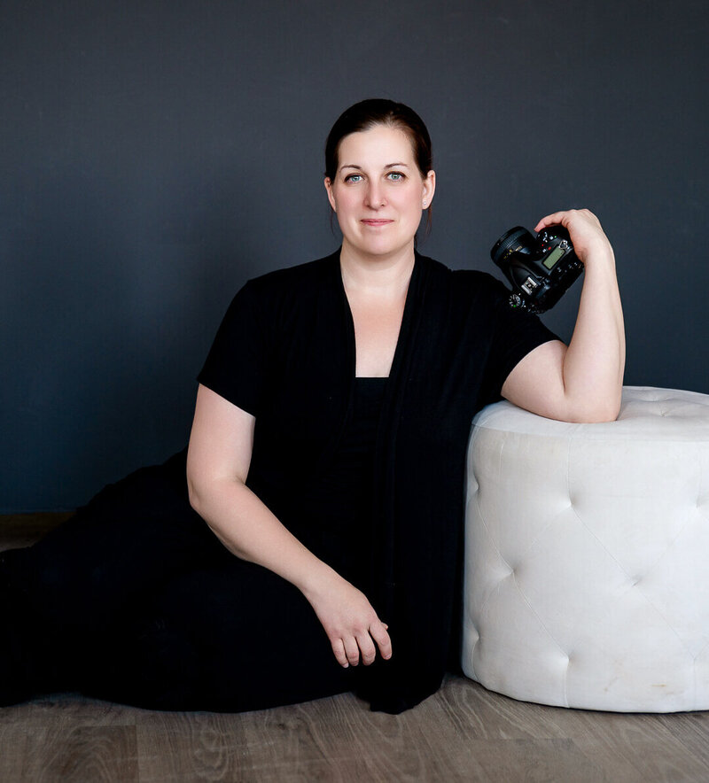 photographer Mandie Schug holding a camera