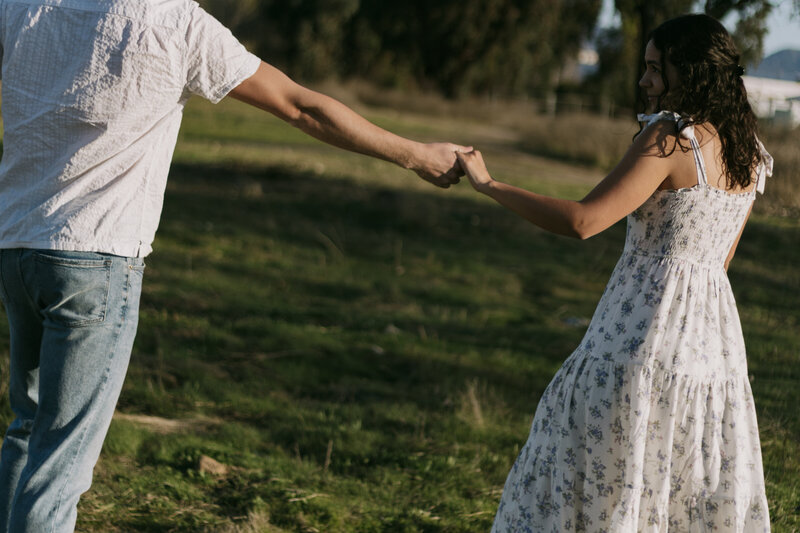 David and Elizabeth holding hands.