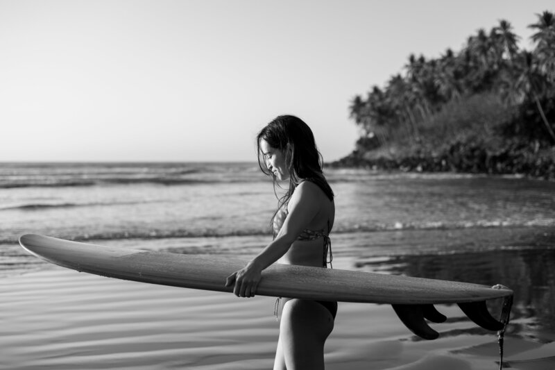 Surfer poses during photoshoot while on surf retreat