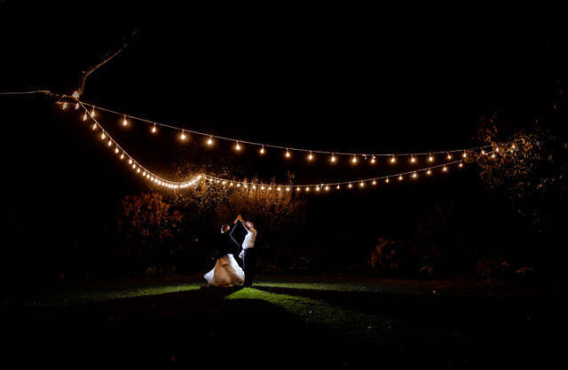 Couple dances under the lights at Londontown Gardens, Maryland Wedding Photography Night Shot