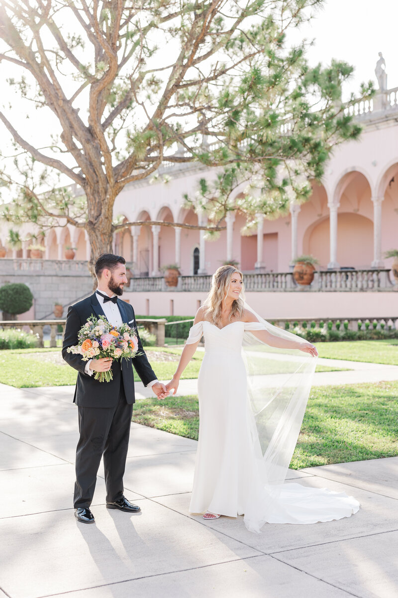 bride and groom holding hands at The Ringling. 