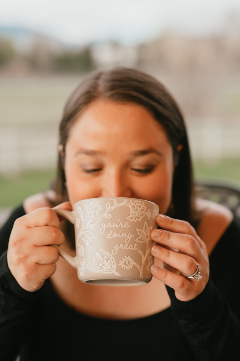 Jennifer sipping coffee from cup
