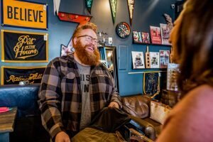 owner of the simple man, boyd, smiling working in store with a happy customer