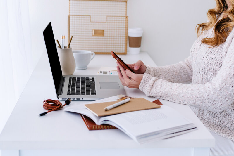 Woman at a desk on her phone