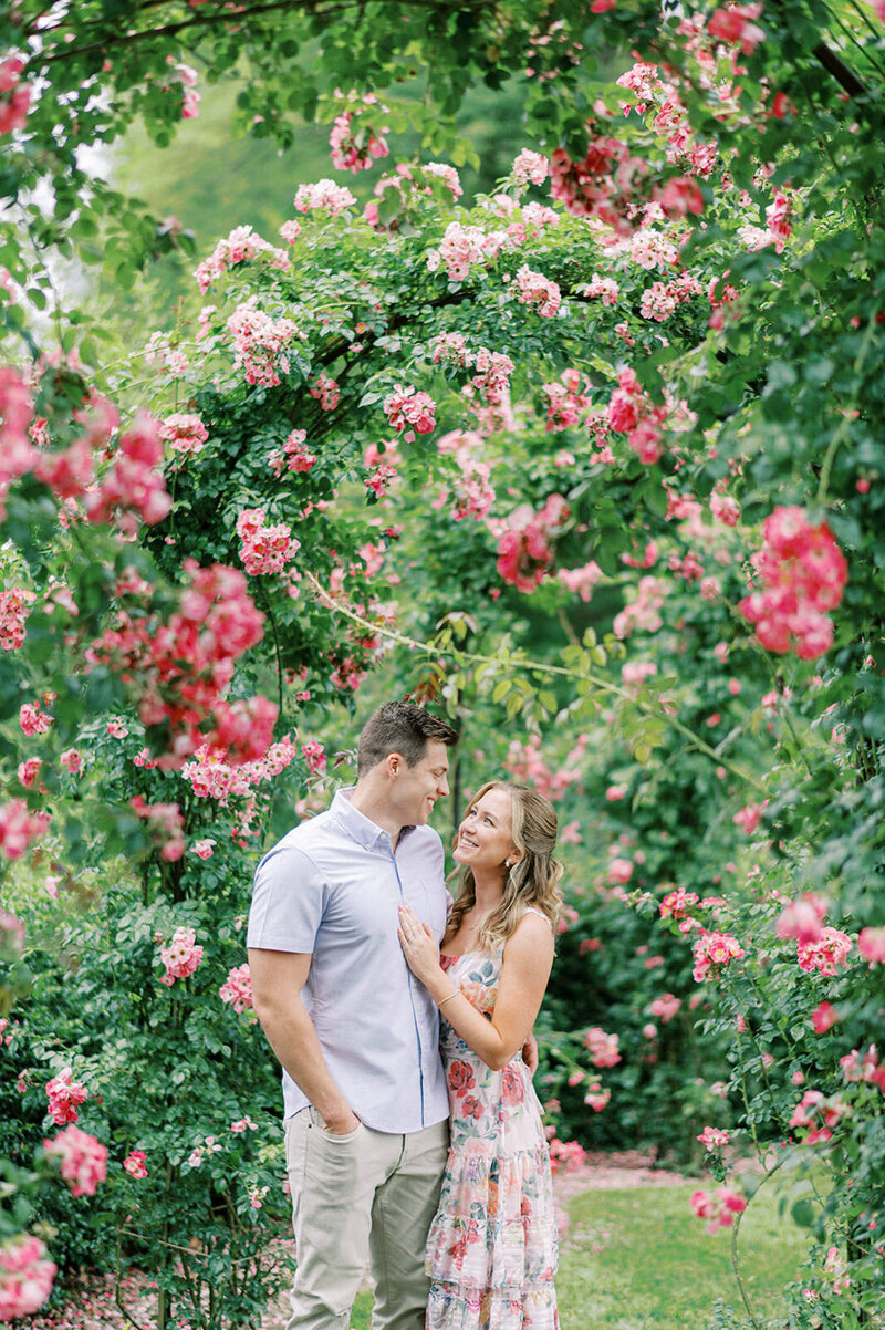 A couple in roses at their Longwood Gardens engagement