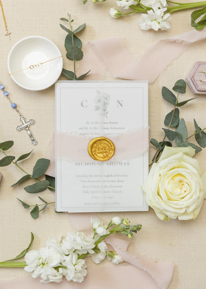 flat lay of a wedding invitation surrounded by flowers