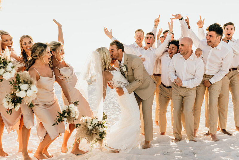 bridal party celebrate on beach