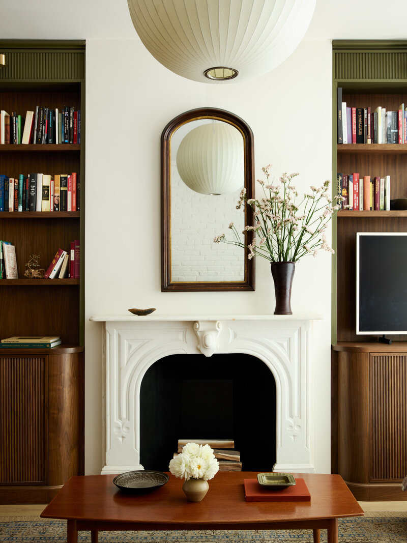 Living room fireplace in a restored Capitol Hill rowhome in Washington, DC, designed by interior design firm, Sanabria & Co.