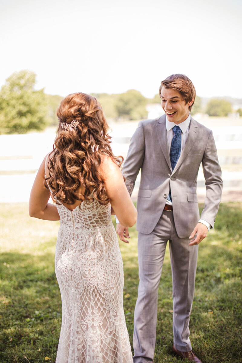 groom sees bride during first look on wedding day