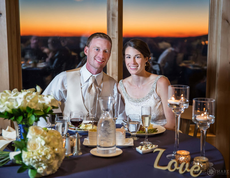 Happy wedding couple eats dinner at sunset at Four Points Lodge in Steamboat Springs
