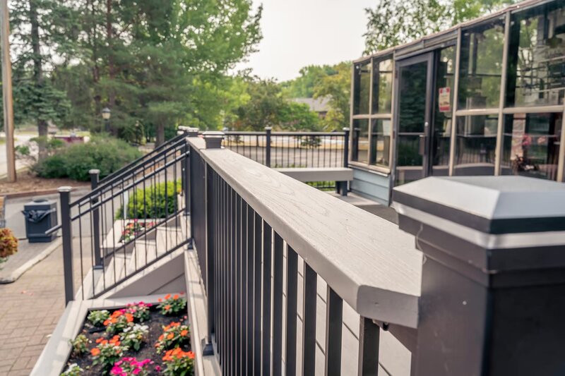 Black aluminum deck railing with Slate Gray drink rail from TimberTech. 