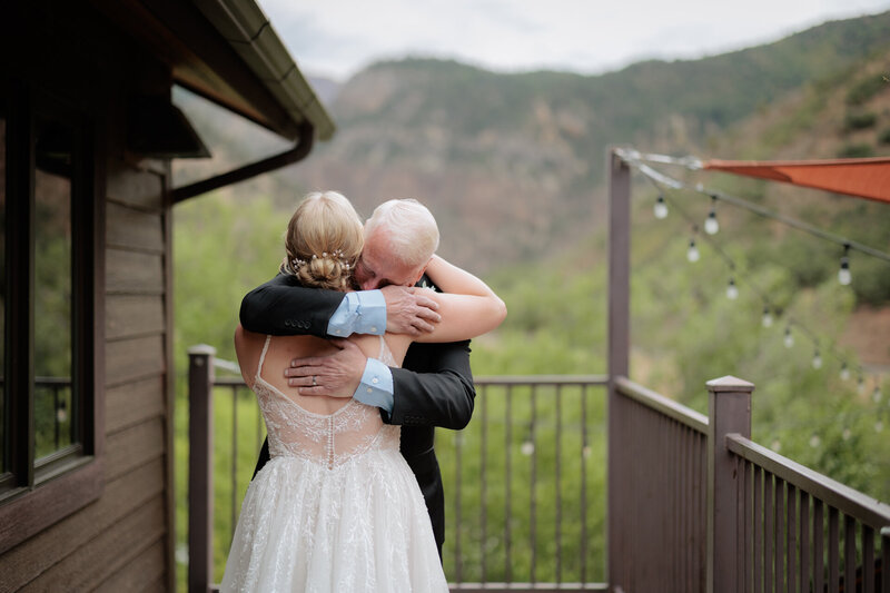 An engaged couple walking down a snowy boardwalk holding hands