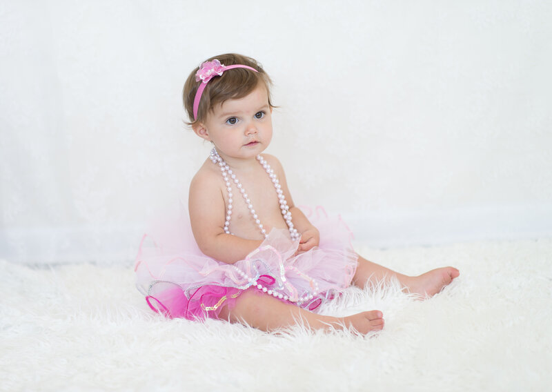 little girl with pink tutu, pearls and a pink headband