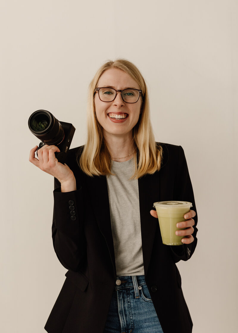 photographer holding camera and matcha latte