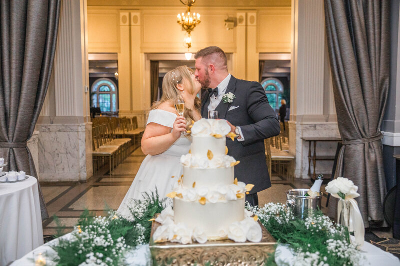 cake cutting photo at a black tie wedding in an estate wedding venue