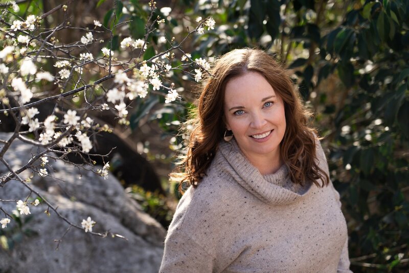 blue-eyed woman in nature smiling