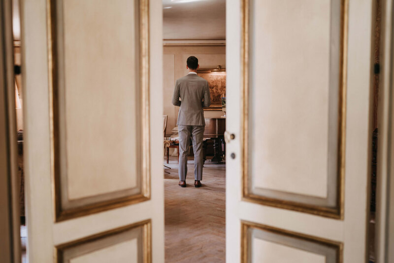 groom waiting for the first look at borgo santo pietro in tuscany