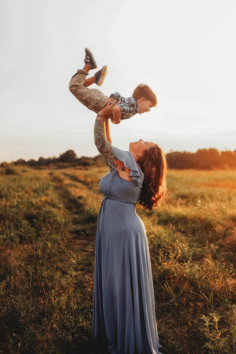 Mother throws her toddler in the air during Family Photoshoot in Charleston, SC.