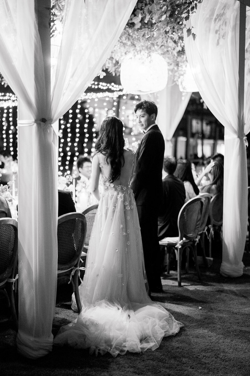 Wedding and Elopement Photography, black and white image of bridal couple standing at the head table