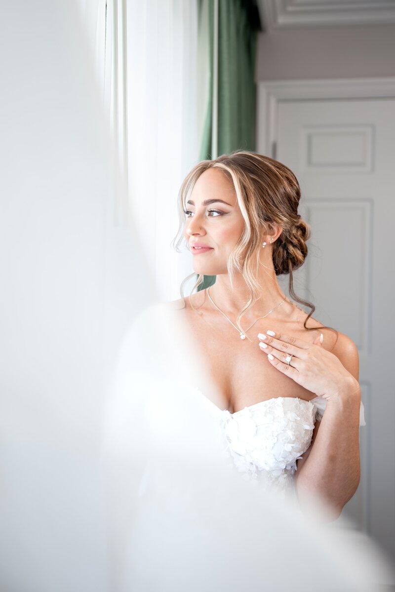 close up of bride laying down on tulle veil