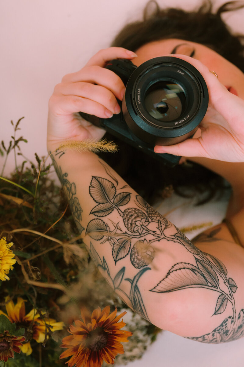 Colleen holds a camera.