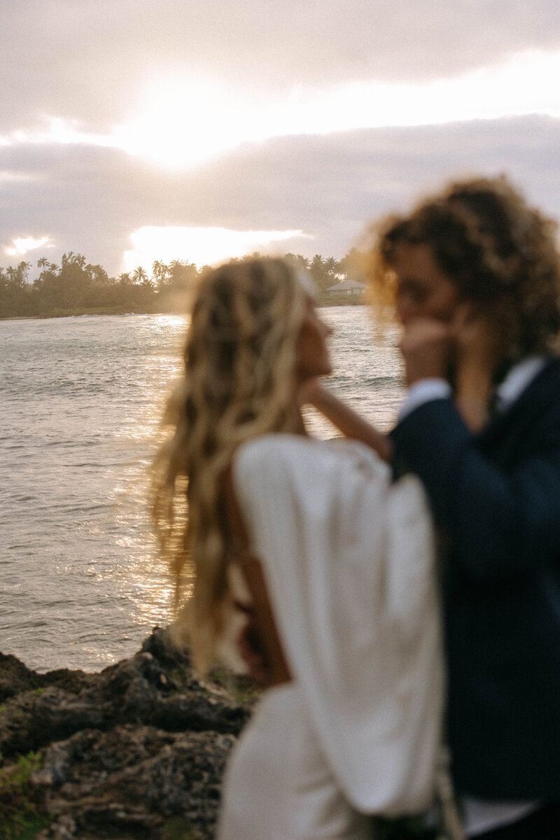 bride and groom embracing on beach