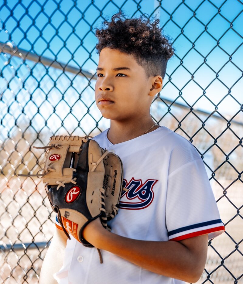 a boy in a baseball uniform