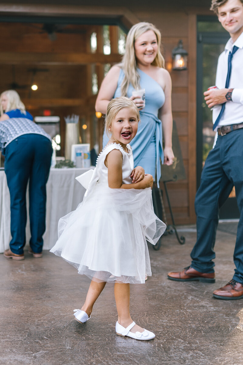 flowergirl smiles at camera at the trillium venue in sevierville tennessee