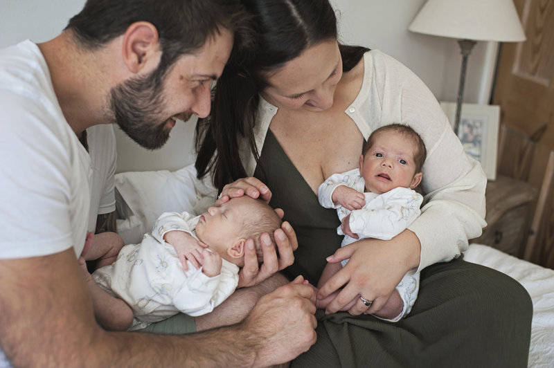 A mother and father hold their baby boy twins during a family photo shoot with Jess Morgan Photography