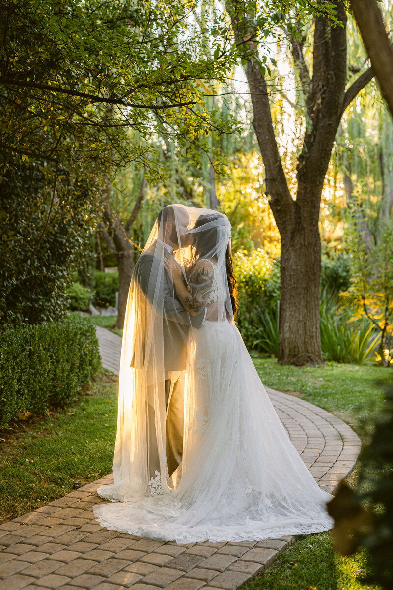 A wedding couple kissing under the veil for their intimate wedding venue in Prescott Arizona