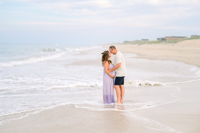 Wedding couple laughing during ceremony on the pier in Kitty Hawk, NC