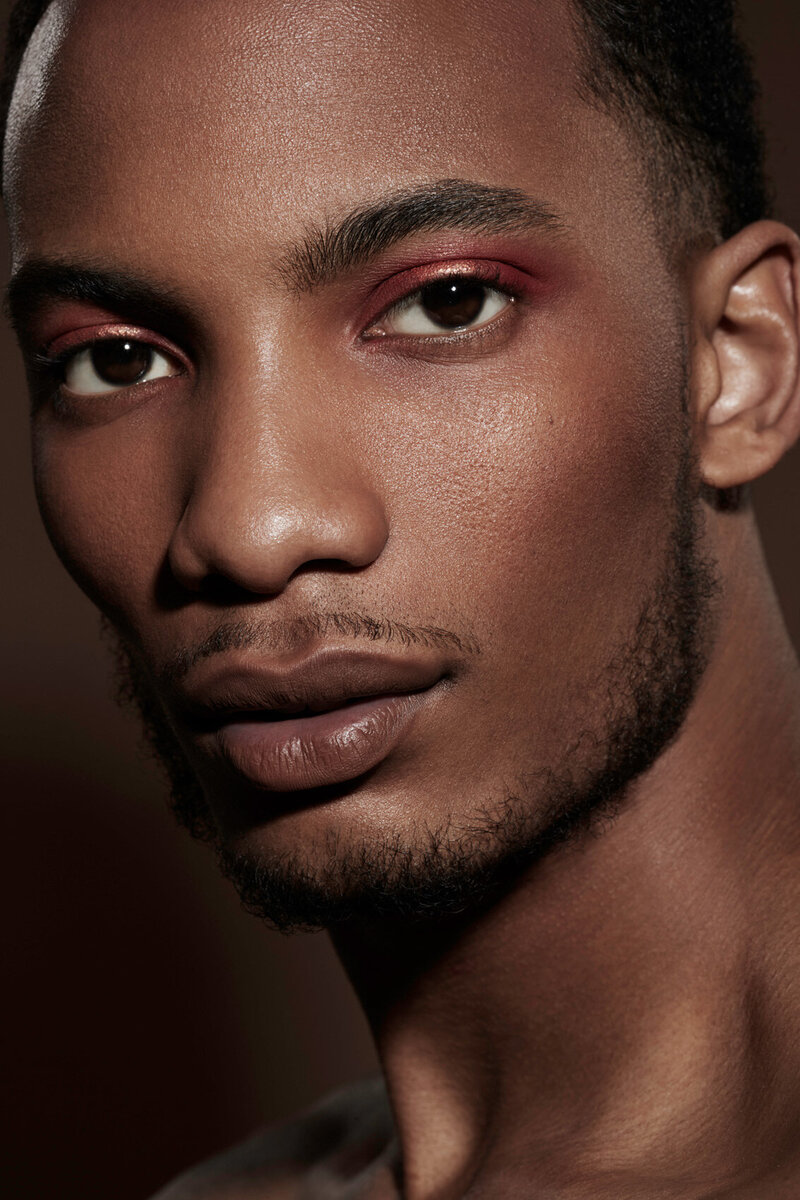 Close-up portrait of Martell with a focused expression, highlighting his strong features, by Ylva Erevall.