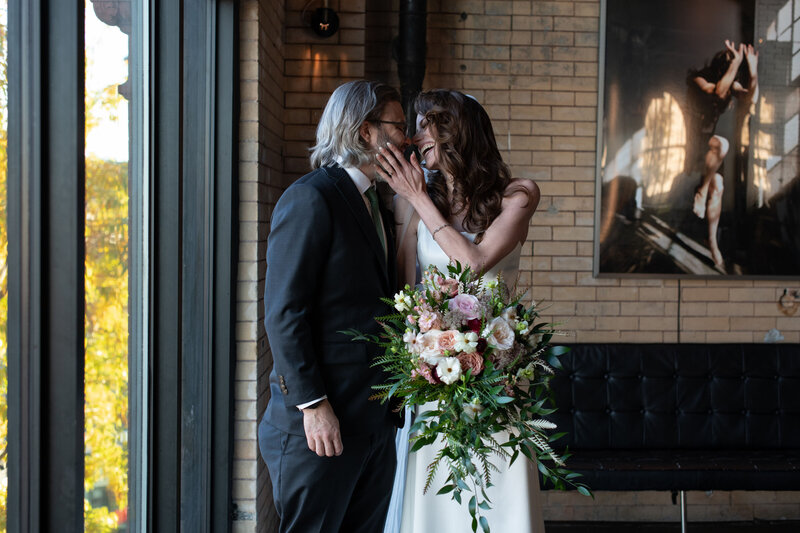 Newly married couple laughing on their wedding day