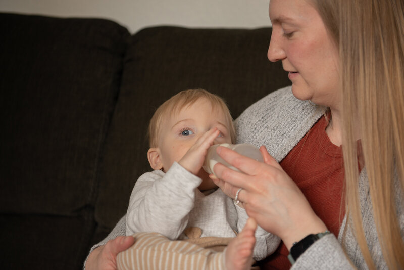 mother bottle feeding her son