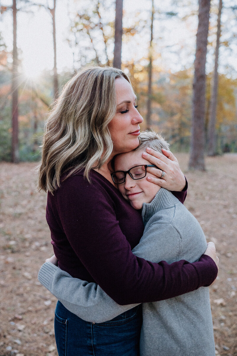 Mother holding and hugging her child during a portrait session taken in Farmington, Missouri. 