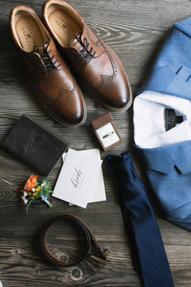 close up of groom's clothes and accessories
