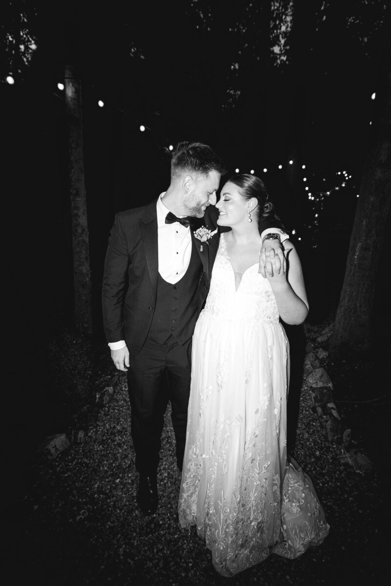 Bride and groom smiling with their eyes closed while leaning their foreheads together