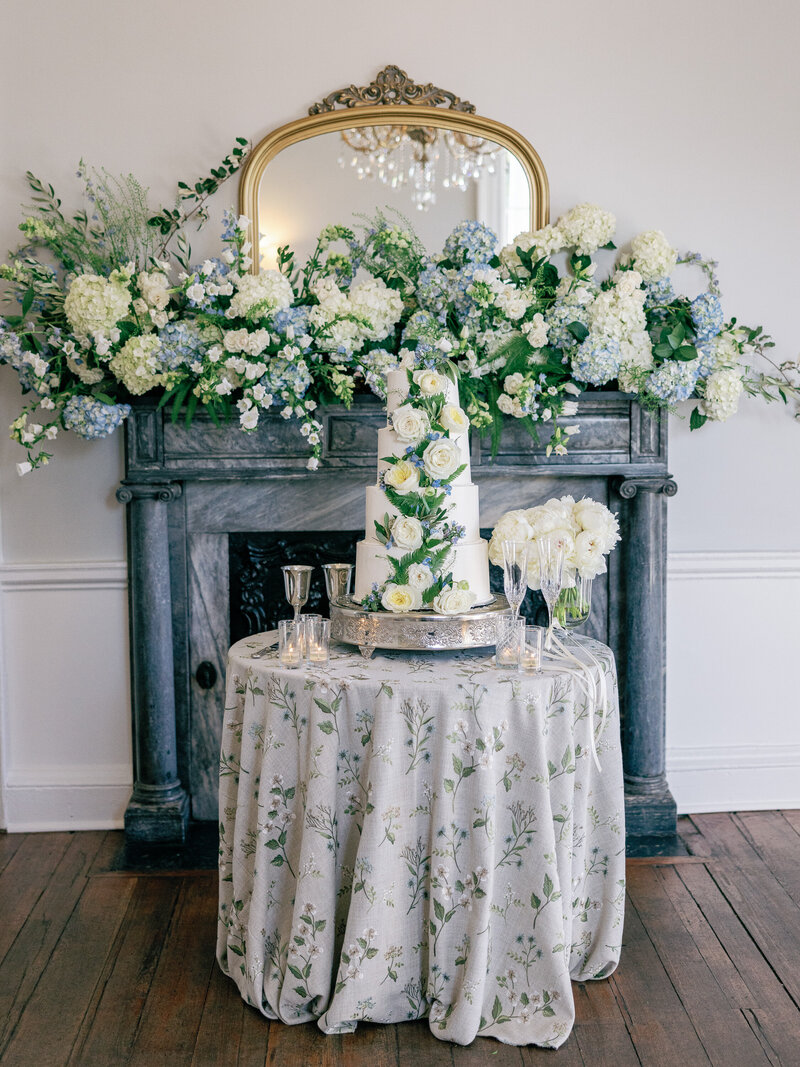 Stunning wedding cake surrounded by lush florals at Gadsden House wedding reception in Charleston