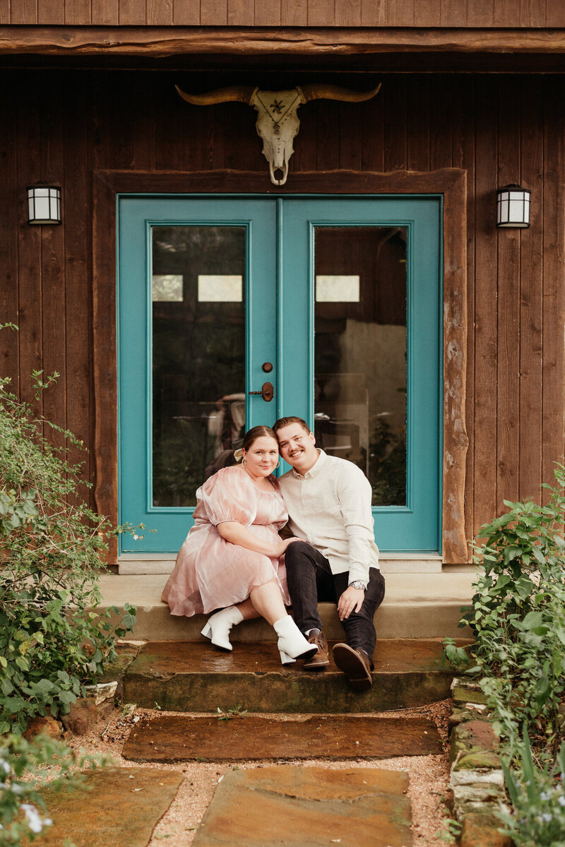 Couple sitting on steps at Hudson Bend Ranch