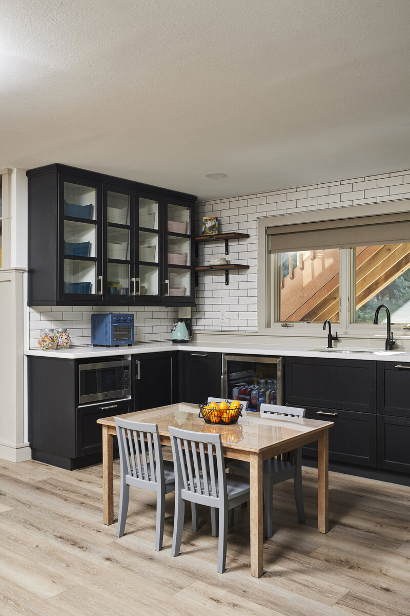 modern, bright kitchen with white cabinetry and wood paneling accents