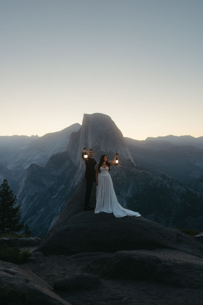 Sunrise Glacier Point Wedding: couple is holding up lanterns during morning twilight
