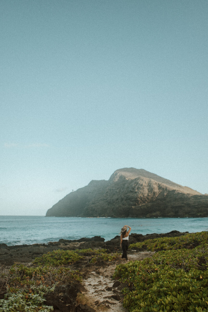 Jenna sitting on rock with hands on knees