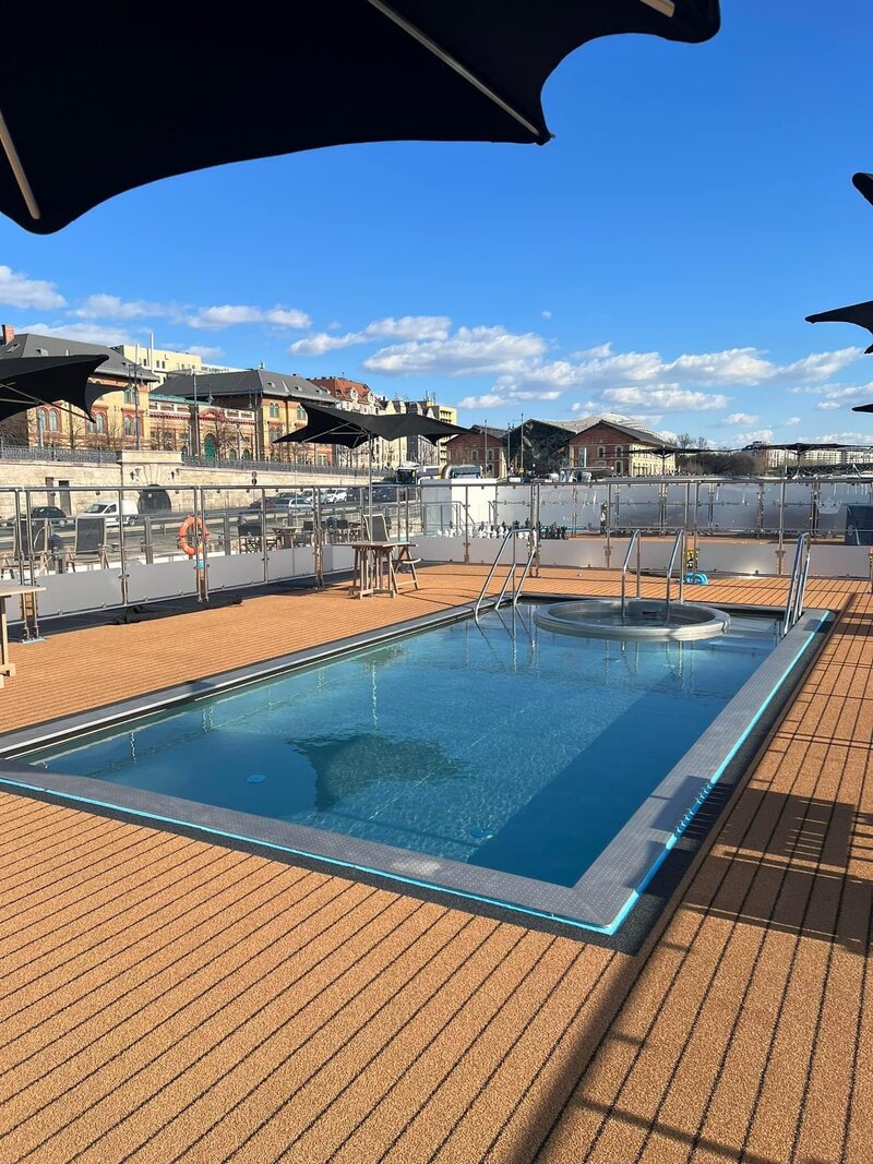 View of the pool and whirlpool on the top deck of the AmaMagna AmaWaterways river cruise ship docked in Budapest, Hungary