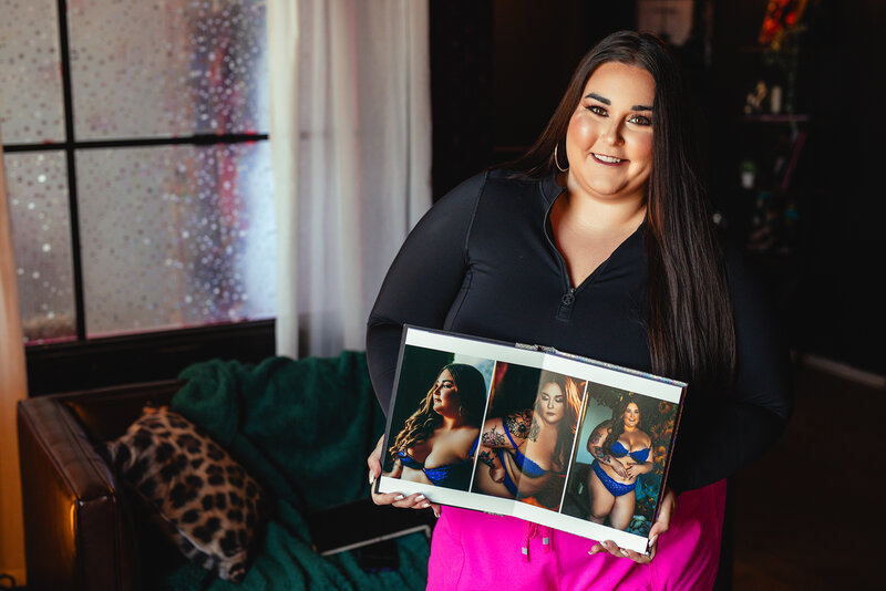 happy confident boudoir client holding luxury album