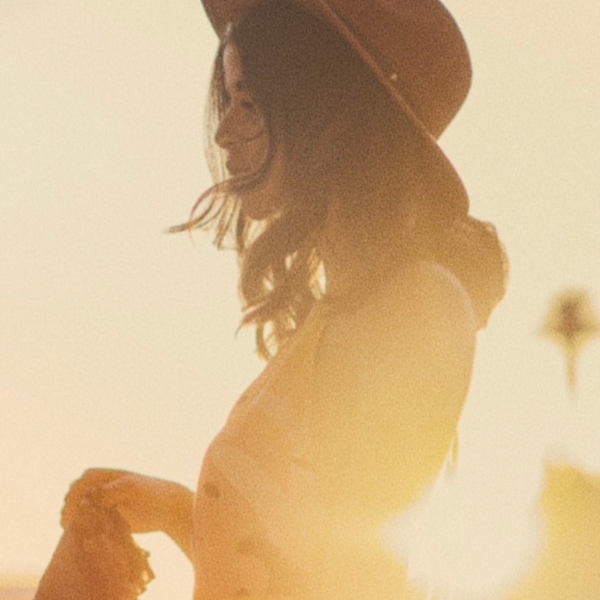 high school senior backlit turned to the side at sunset